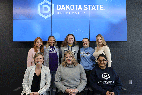 Five DSU students are benefiting from scholarships through a new partnership with UKGs employee resource group. Pictured are Paige Phinney back left, Bella Maxwell, Catherine Hoier, Mikaila Fluth, and Joelle Malacko. Also pictured are Jill Ruhd, with the DSU Foundation, Dr. Ashley Podhradsky, vice president for Research and Economic Development, and Kanthi Narukonda, assistant professor and director of CybHER.