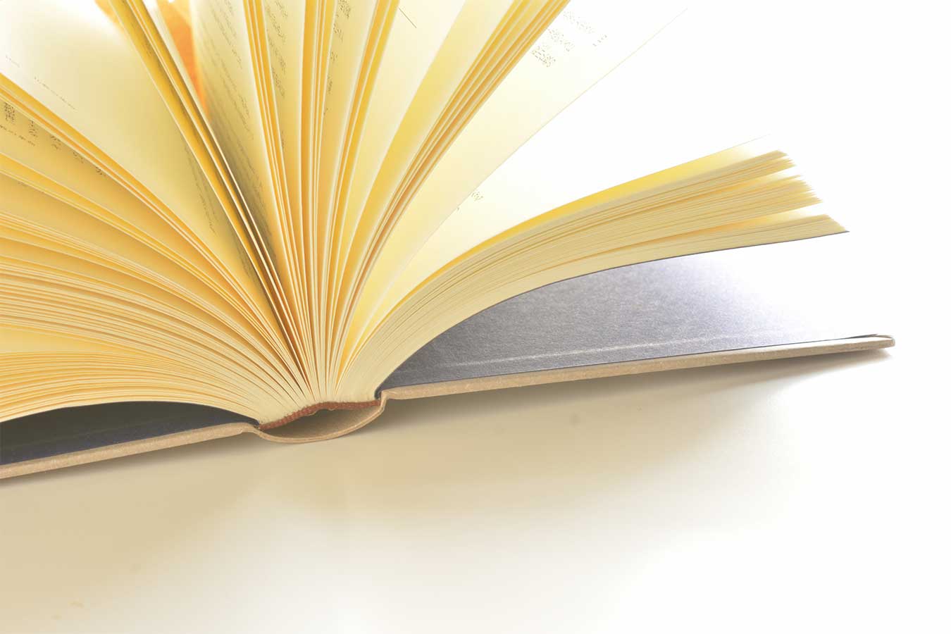 A book flipped open on a counter.